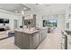 Bright kitchen boasts an island with bar seating and a breakfast nook overlooking the backyard at 7542 Windy Hill Cv, Bradenton, FL 34202