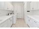 Well-equipped laundry room with washer, dryer, ample cabinets, and counter space at 7542 Windy Hill Cv, Bradenton, FL 34202