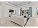 Spacious living room with tray ceilings, tile flooring, and modern decor at 7542 Windy Hill Cv, Bradenton, FL 34202