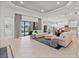 Open-concept living room with tile flooring and sliding glass doors to a pool at 7542 Windy Hill Cv, Bradenton, FL 34202