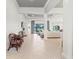 Bright and airy living room featuring neutral tones, tile floors, and large windows at 7542 Windy Hill Cv, Bradenton, FL 34202