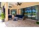 Outdoor patio area with ample seating and a view of the pool and golf course at 7542 Windy Hill Cv, Bradenton, FL 34202