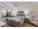 Inviting primary bedroom featuring a ceiling fan and tray ceiling, complemented by ample natural light at 8291 Varenna Dr, Sarasota, FL 34231
