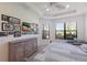 Comfortable bedroom with stylish dresser, large windows, and a ceiling fan for added comfort at 8291 Varenna Dr, Sarasota, FL 34231