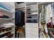 Bright walk-in closet featuring custom shelving, drawers, and ample hanging storage for organized wardrobe space at 8291 Varenna Dr, Sarasota, FL 34231