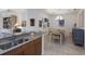 Bright dining room with a view of kitchen, featuring elegant chandelier and stylish decor at 8291 Varenna Dr, Sarasota, FL 34231
