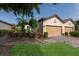 A two-car garage with brick paver driveway, complemented by lush landscaping and a well-maintained lawn at 8291 Varenna Dr, Sarasota, FL 34231