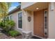The front door offers curb appeal, featuring a sidelight, a decorative wreath, and manicured landscaping at 8291 Varenna Dr, Sarasota, FL 34231