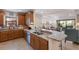 Well-lit kitchen featuring granite countertops, stainless steel appliances, and a convenient breakfast bar at 8291 Varenna Dr, Sarasota, FL 34231