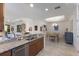 Open-concept kitchen with granite countertop, and dining area beyond, creating an inviting space at 8291 Varenna Dr, Sarasota, FL 34231
