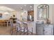 An open kitchen featuring granite countertops, stainless steel appliances, and a breakfast bar with seating at 8291 Varenna Dr, Sarasota, FL 34231