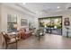 Comfortable living room with tile floors, lots of natural light, and sliding doors to a covered patio at 8291 Varenna Dr, Sarasota, FL 34231