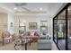 Bright living room featuring tile floors, a ceiling fan, and sliding glass doors to an outdoor patio at 8291 Varenna Dr, Sarasota, FL 34231
