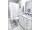 Bright bathroom boasts a shower and bathtub combination with modern fixtures at 831 Palmetto Ne Dr, Port Charlotte, FL 33952