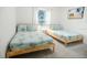 Twin bedroom with hardwood frames, bright window and attractive wall art at 831 Palmetto Ne Dr, Port Charlotte, FL 33952