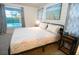 Serene bedroom with a view of the pool, featuring stylish decor and a relaxing ambiance at 831 Palmetto Ne Dr, Port Charlotte, FL 33952