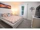 Cozy bedroom features modern decor, a bright window, and comfortable furnishings at 831 Palmetto Ne Dr, Port Charlotte, FL 33952