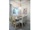 Bright dining area features a modern glass table, stylish chairs, and neutral décor at 831 Palmetto Ne Dr, Port Charlotte, FL 33952