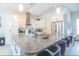 Modern kitchen featuring an island with bar seating, stainless steel appliances, and pendant lighting at 831 Palmetto Ne Dr, Port Charlotte, FL 33952