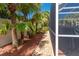 Well-maintained backyard with tropical landscaping and a path along the fence at 866 Oak Briar Ln, Osprey, FL 34229