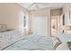 Bedroom with a bed, dresser, closet, and window with sheer curtains at 866 Oak Briar Ln, Osprey, FL 34229