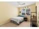 Cozy bedroom with ceiling fan, natural light, and a neutral color palette at 866 Oak Briar Ln, Osprey, FL 34229