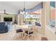 Bright breakfast nook featuring a round table and views of the screened-in pool area at 866 Oak Briar Ln, Osprey, FL 34229