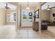Inviting foyer with neutral tile flooring, transom windows, and a decorative console table at 866 Oak Briar Ln, Osprey, FL 34229