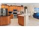 Well-appointed kitchen featuring stainless steel appliances, ample cabinet space, and an island with dark countertops at 866 Oak Briar Ln, Osprey, FL 34229