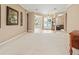 Open-concept living area with a carpeted floor and an archway looking into the foyer and front door at 866 Oak Briar Ln, Osprey, FL 34229