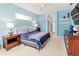 Bright bedroom with blue walls, carpeted floors, and coordinated furnishings at 866 Oak Briar Ln, Osprey, FL 34229