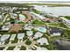 Panoramic aerial view showcasing the neighborhood with water views, community amenities, and lush greenery at 9412 Concord Cir, Bradenton, FL 34210