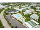 Picturesque aerial view of a community with a swimming pool, shuffleboard courts, and waterway access at 9412 Concord Cir, Bradenton, FL 34210