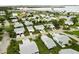 Expansive aerial view of a residential area with well-kept homes, manicured lawns, and partial waterfront views at 9412 Concord Cir, Bradenton, FL 34210