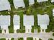 Overhead view of neatly aligned homes with well-manicured lawns, carports, and street access at 9412 Concord Cir, Bradenton, FL 34210