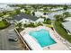 Aerial view of a community with a pool, pond, clubhouse, and well-maintained landscaping at 9412 Concord Cir, Bradenton, FL 34210