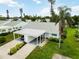 Aerial view of a single-Gathering home with a carport, landscaped yard, and mature palm trees at 9412 Concord Cir, Bradenton, FL 34210