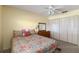 Cozy bedroom featuring a floral comforter, dresser, and spacious closet, offering comfort and functionality at 9412 Concord Cir, Bradenton, FL 34210
