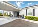 Charming building entrance with benches, potted plants, a canopy, and a decorative compass on the walkway at 9412 Concord Cir, Bradenton, FL 34210