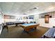 Community game room with two pool tables, comfortable seating, and classic decor creating a recreational space at 9412 Concord Cir, Bradenton, FL 34210