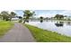 Scenic view of a tranquil pond with lush green landscaping and a walking path at 9412 Concord Cir, Bradenton, FL 34210