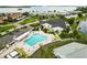 Overhead shot of the community pool, parking, and amenities near the white clubhouse and waterway at 9412 Concord Cir, Bradenton, FL 34210