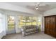 Inviting sunroom filled with natural light from large windows, perfect for relaxation and enjoying the outdoors at 9412 Concord Cir, Bradenton, FL 34210