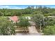 Aerial view of a home with a well-maintained lawn surrounded by mature trees at 1126 Barclay Wood Dr, Ruskin, FL 33570