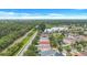 Aerial view of a tranquil neighborhood with a lake, green spaces, and well-kept homes with lush landscaping at 1126 Barclay Wood Dr, Ruskin, FL 33570