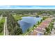 Aerial view showcasing a serene lake surrounded by lush greenery and well-maintained homes, offering a peaceful community setting at 1126 Barclay Wood Dr, Ruskin, FL 33570