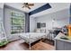Cozy bedroom with large arched window, ceiling fan and laminate flooring at 1126 Barclay Wood Dr, Ruskin, FL 33570