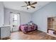 This bedroom features hardwood floors, a window, and a ceiling fan at 1126 Barclay Wood Dr, Ruskin, FL 33570