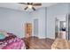 This bedroom features hardwood floors, a window, and a ceiling fan at 1126 Barclay Wood Dr, Ruskin, FL 33570