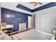 This bedroom features a dark blue accent wall, a desk and a closet at 1126 Barclay Wood Dr, Ruskin, FL 33570